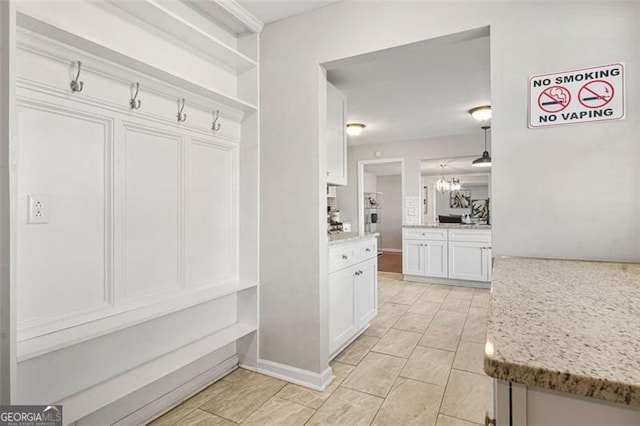 mudroom featuring a chandelier