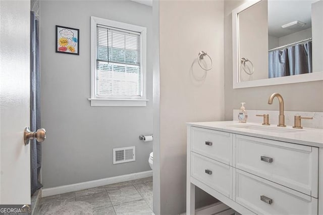 bathroom featuring toilet and vanity