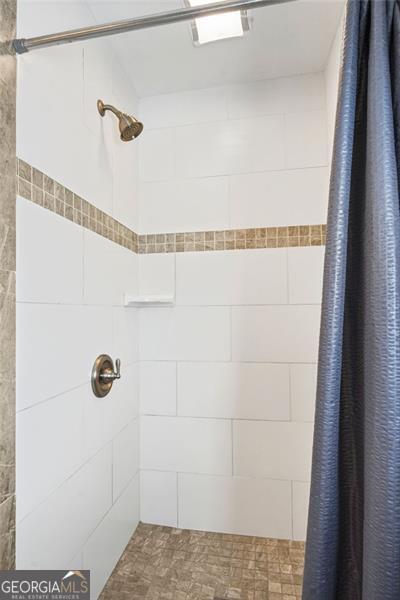 bathroom with a shower with shower curtain