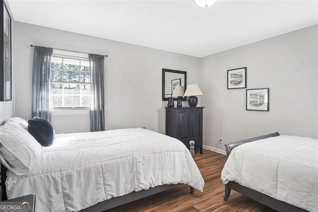 bedroom with dark hardwood / wood-style floors