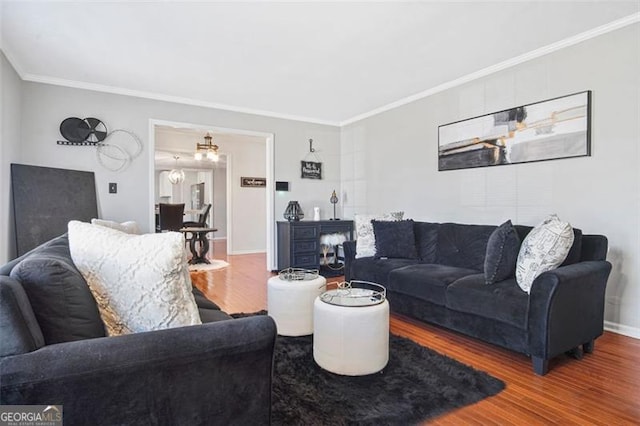 living room featuring wood-type flooring and ornamental molding