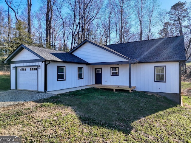 single story home featuring a garage and a front yard