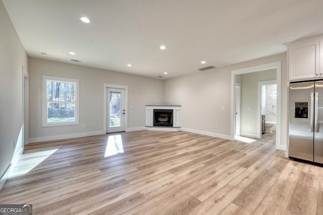 unfurnished living room with light wood-type flooring