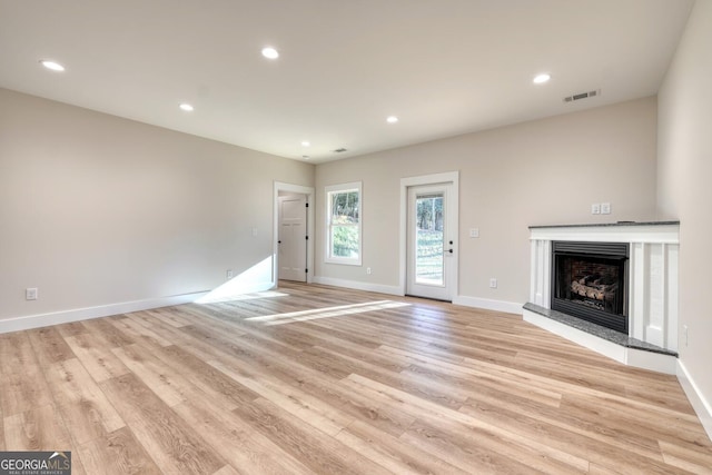 unfurnished living room with light wood-type flooring