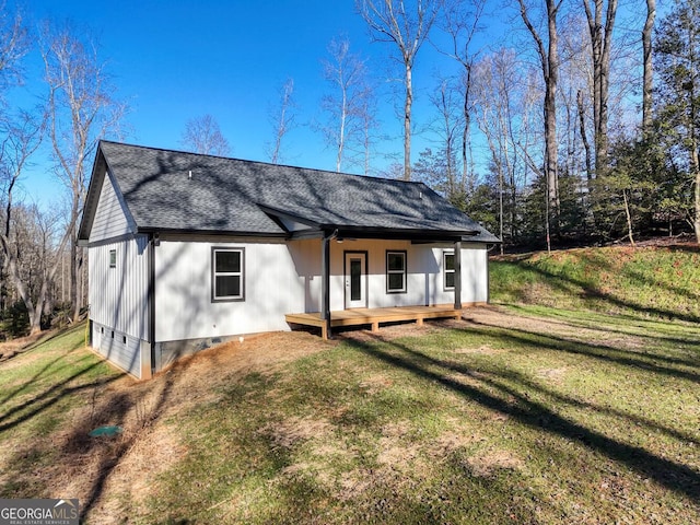 rear view of property with a yard