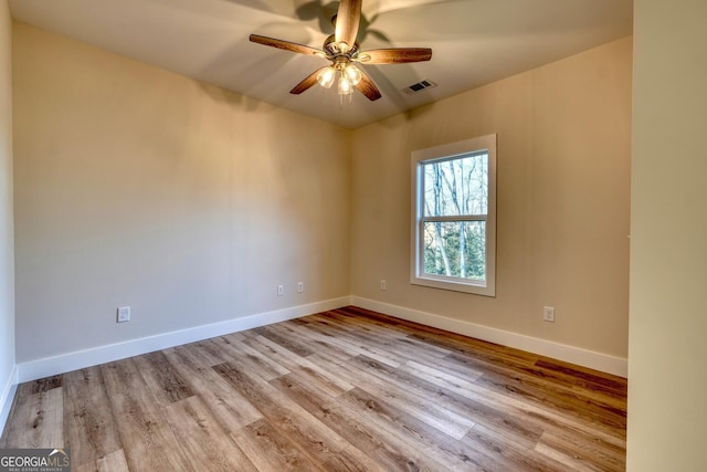 unfurnished room with light wood-type flooring and ceiling fan