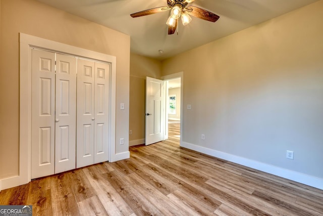 unfurnished bedroom with a closet, ceiling fan, and light wood-type flooring