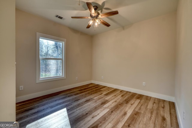 empty room with ceiling fan and light wood-type flooring