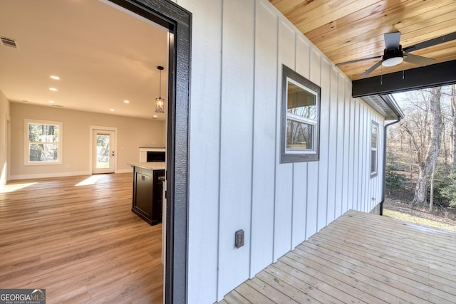 wooden deck featuring ceiling fan