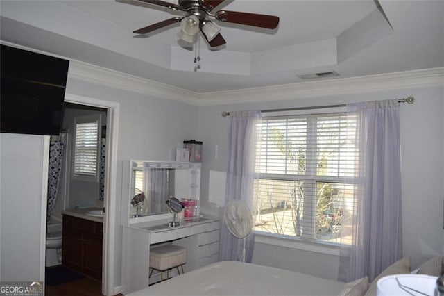 bedroom featuring ceiling fan, ornamental molding, and a raised ceiling