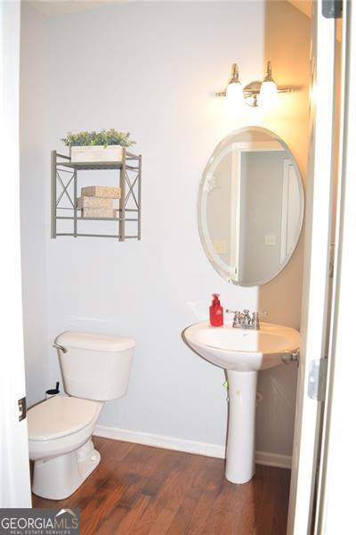 bathroom with wood-type flooring and toilet