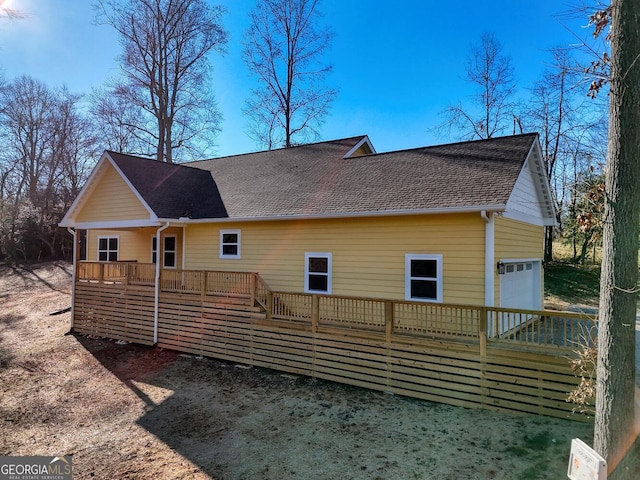 back of property with covered porch and a garage