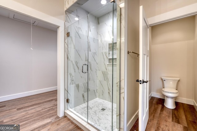 bathroom with wood-type flooring, toilet, and walk in shower