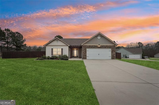 view of front of house with a garage and a yard