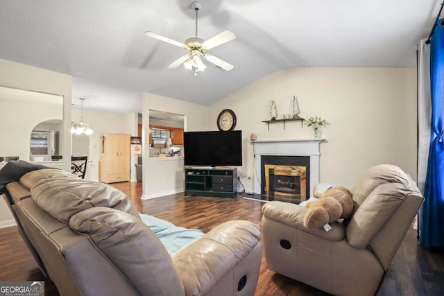 living room featuring hardwood / wood-style flooring, ceiling fan with notable chandelier, and vaulted ceiling