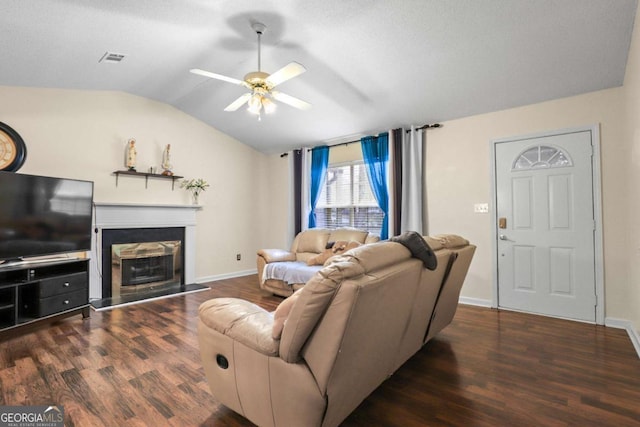 living room with lofted ceiling, a textured ceiling, dark hardwood / wood-style flooring, and ceiling fan