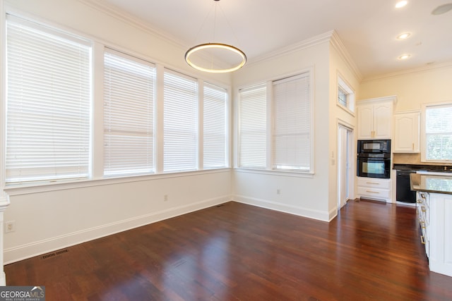 kitchen with decorative light fixtures, white cabinets, black appliances, and crown molding