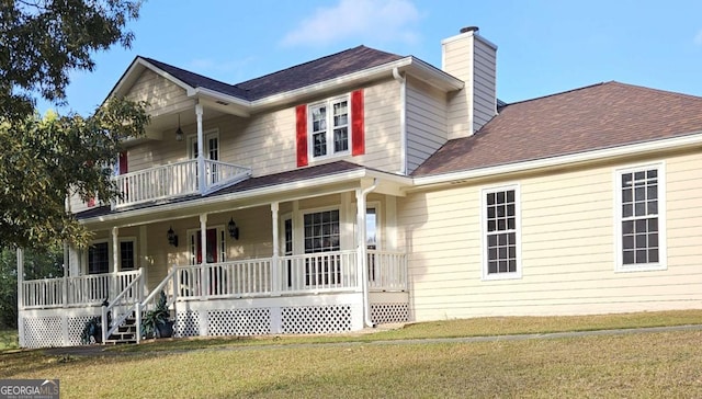 view of front of house featuring a balcony, a front yard, and a porch