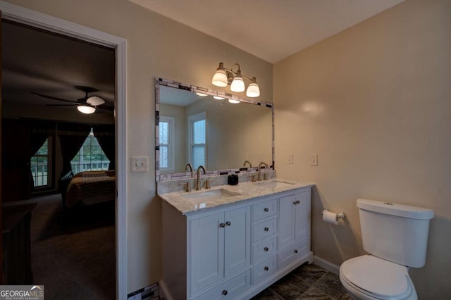 bathroom with toilet, ceiling fan, and vanity