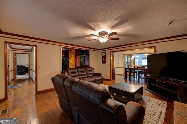 living room with wood-type flooring, ceiling fan with notable chandelier, a textured ceiling, and crown molding