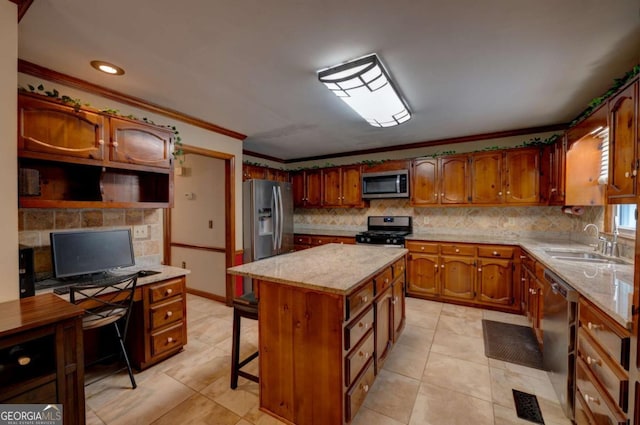 kitchen with appliances with stainless steel finishes, a kitchen island, tasteful backsplash, sink, and crown molding