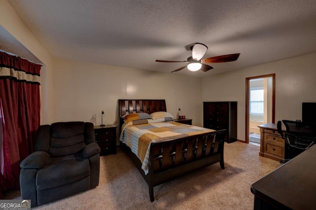 carpeted bedroom featuring ceiling fan, connected bathroom, and a textured ceiling