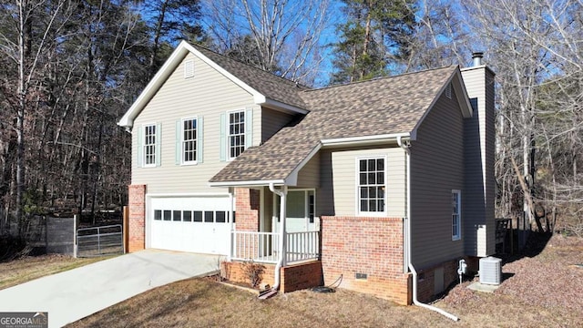 view of front of house featuring a garage and cooling unit