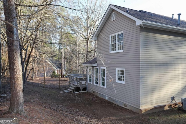 view of property exterior featuring a shingled roof and crawl space