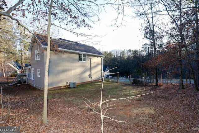 view of home's exterior with roof with shingles