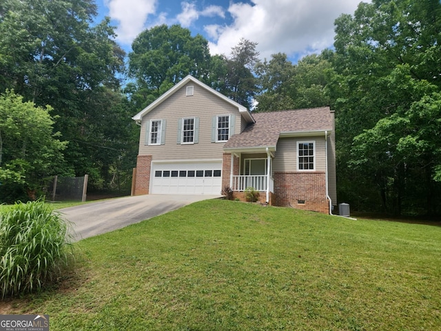 tri-level home with crawl space, a front yard, a garage, brick siding, and concrete driveway