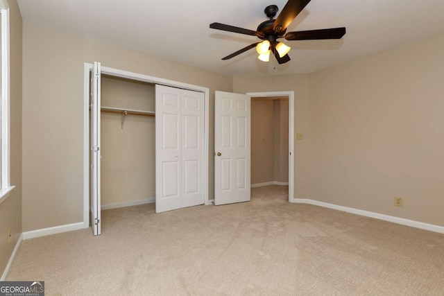 unfurnished bedroom with ceiling fan and light carpet