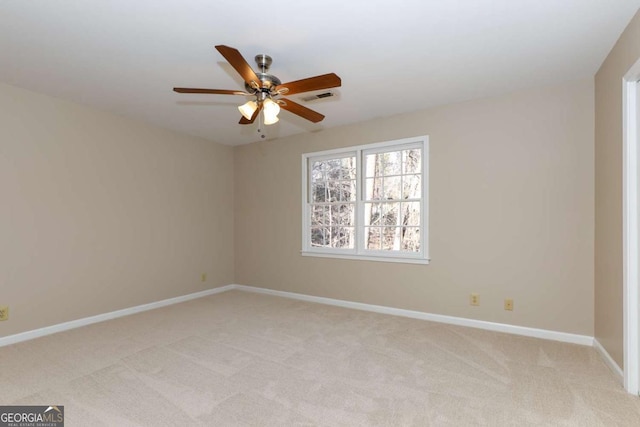 unfurnished room with light colored carpet, baseboards, ceiling fan, and visible vents