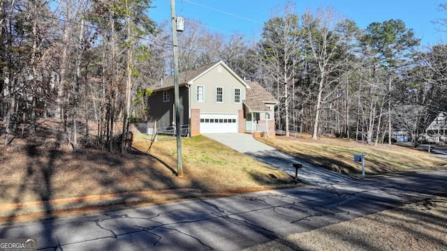 view of front facade with a garage, a front lawn, and concrete driveway