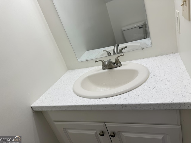 details featuring vanity and toilet