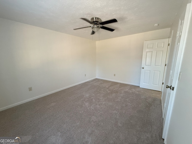 carpeted spare room with ceiling fan and a textured ceiling