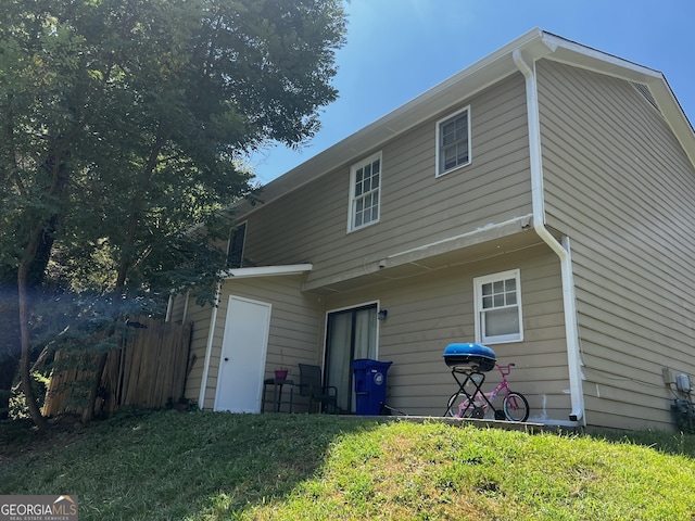 rear view of property with a yard