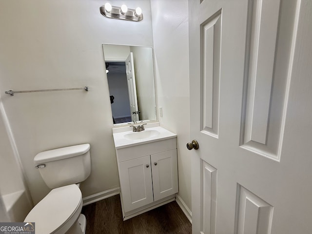 bathroom featuring vanity, hardwood / wood-style floors, and toilet