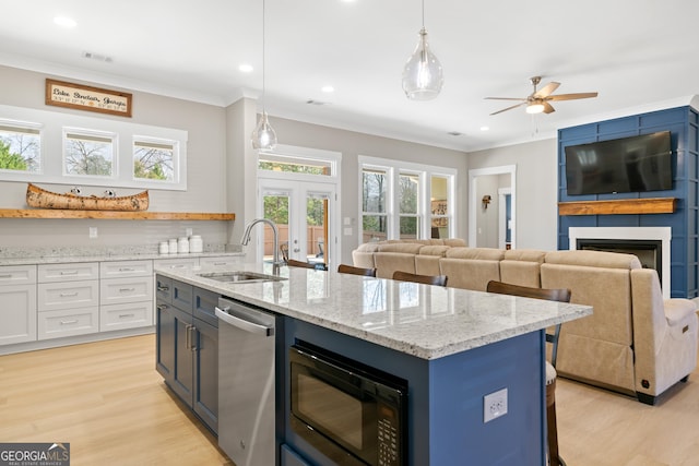 kitchen with sink, black microwave, dishwasher, and decorative light fixtures