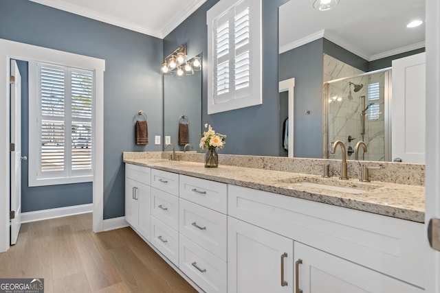 bathroom with vanity, hardwood / wood-style flooring, walk in shower, and ornamental molding