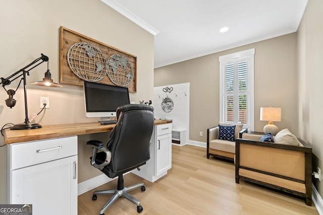 office space with light wood-type flooring and ornamental molding