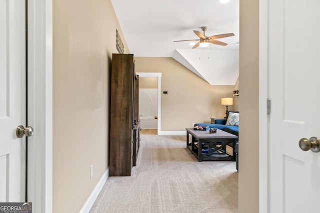 hall with light carpet and lofted ceiling