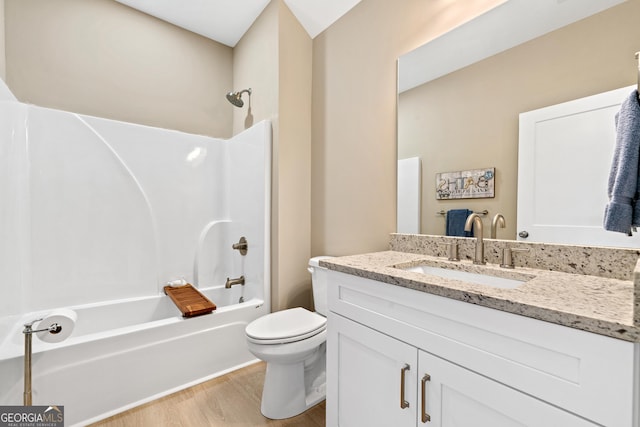 full bathroom with hardwood / wood-style flooring, shower / tub combination, vanity, and toilet