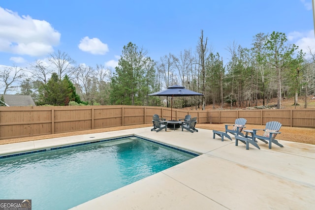 view of pool featuring a fire pit and a patio