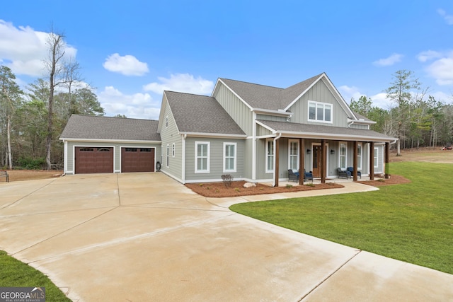 craftsman inspired home with a garage, a front lawn, and a porch