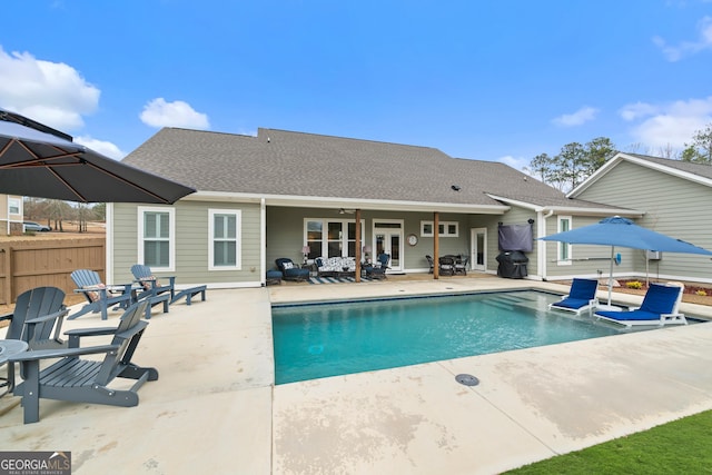 view of swimming pool featuring ceiling fan, french doors, and a patio