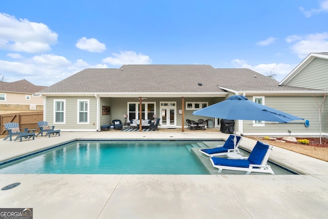 view of swimming pool featuring a patio area and french doors