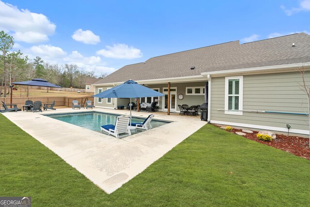 view of swimming pool featuring a lawn and a patio