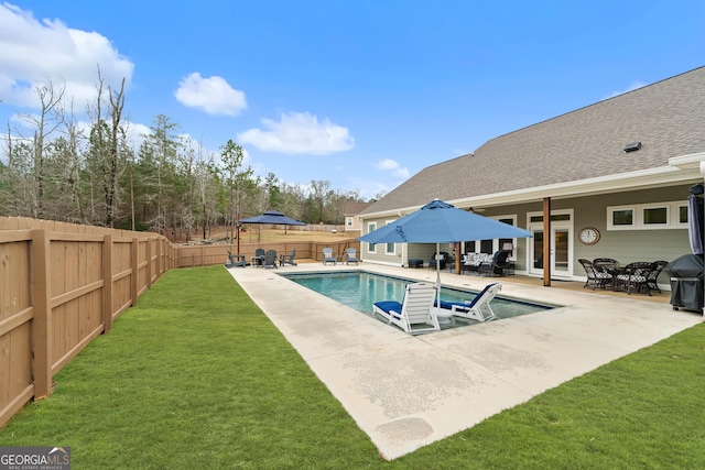 view of swimming pool with a patio area, a yard, and grilling area