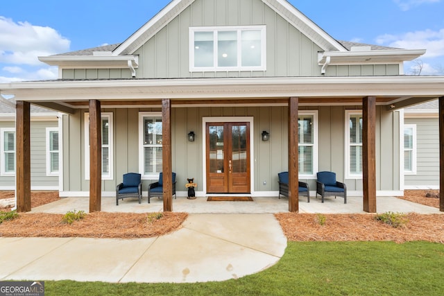 entrance to property with a porch and french doors