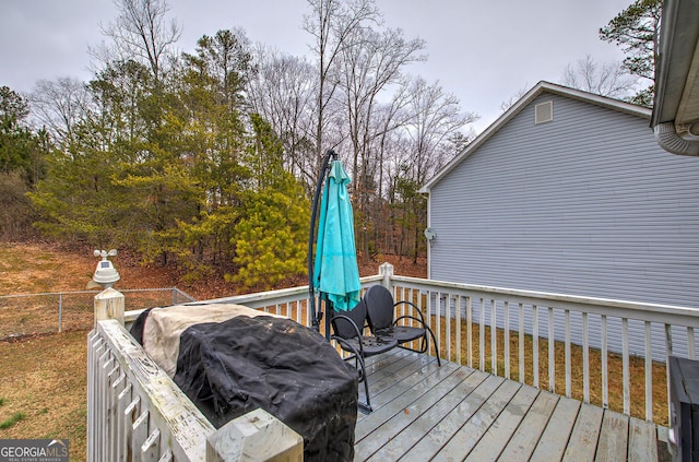 wooden terrace with a grill